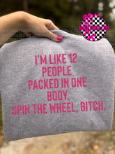 Load image into Gallery viewer, I’m like 12 people packed in one body. Spin the wheel bitch. on grey WITH HOT PINK LETTERS hoodie, crewneck, long sleeve or graphic tee - Mavictoria Designs Hot Press Express
