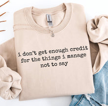 Load image into Gallery viewer, I don’t get enough credit for the things I manage not to say on sand hoodie, crewneck, long sleeve or graphic tee - Mavictoria Designs Hot Press Express
