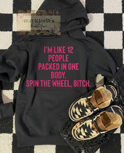Load image into Gallery viewer, I’m like 12 people packed in one body. Spin the wheel bitch. on black with TEAL or hot pink letters hoodie, crewneck, long sleeve or graphic tee - Mavictoria Designs Hot Press Express
