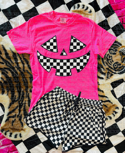 Checkered Jack o lantern on neon pink graphic tee - Mavictoria Designs Hot Press Express