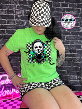 Load image into Gallery viewer, Neon green checkered HORROR COLLECTION graphic tee - Mavictoria Designs Hot Press Express
